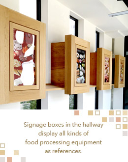 Signage boxes in the hallway display all kinds of food processing equipment as references